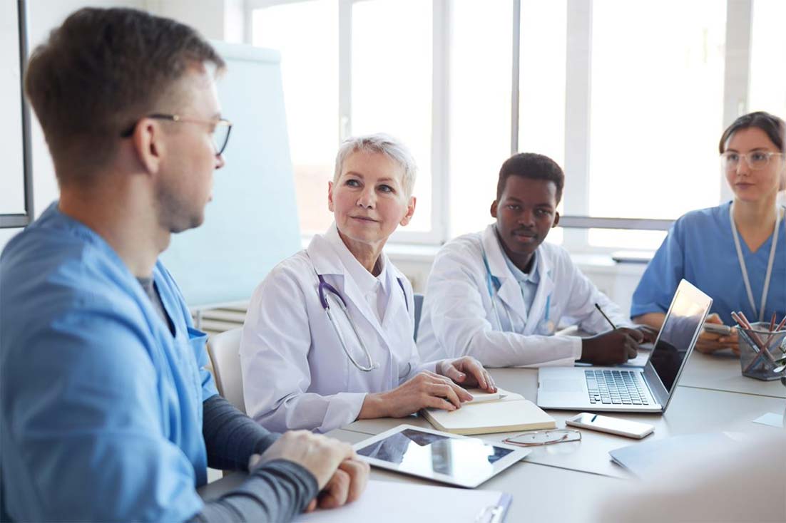 Four physicians in a meeting